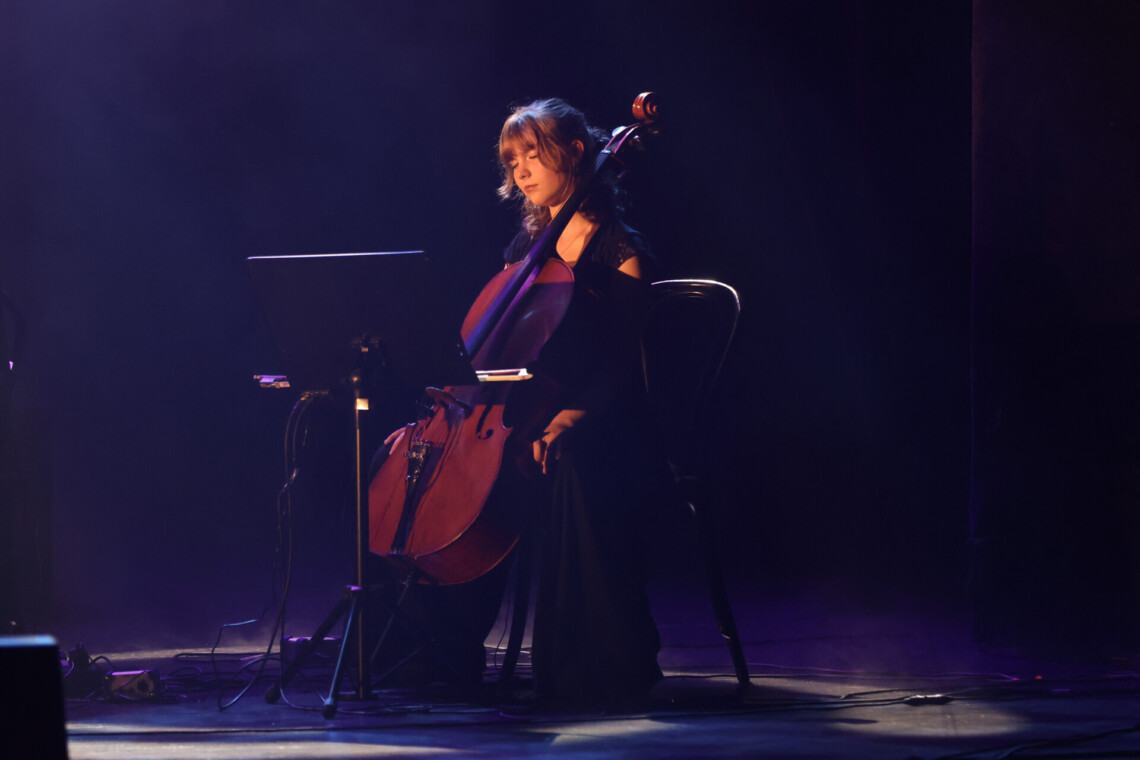 Kobieta siedząca na krześle z wiolonczelą