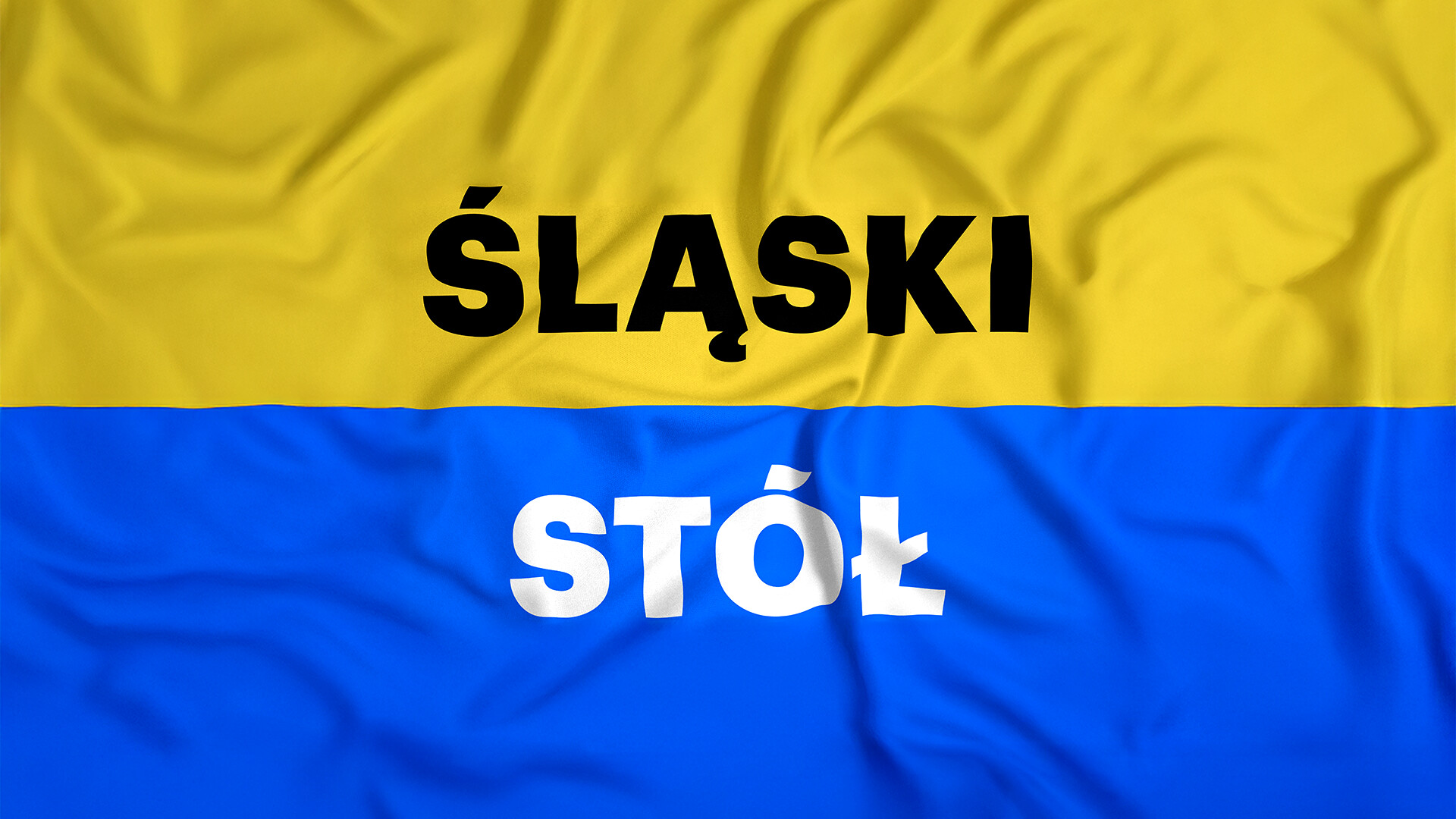 Flaga śląska (u góry żółty, na dole niebieski), na środku napis śląski stół (pierwsze słowo czarne, drugie białe)